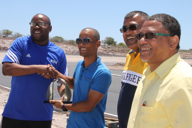 Jamir Claxton, Director of Sports on Nevis and a member of the Nevis Primary Schools Championship’s organising committee presents a token of appreciation to Jason Clarke, Managing Director of Gulf Insurance Limited on April 06, 2017, at Long Point for the company’s avid support to the championships. (L-r) S. Nandpersad, Director of Assuria Group, Gulf’s parent company based in Suriname and John Barkely, Gulf Insurance Limited’s Operations/Claims Manager
